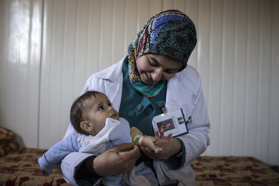 Bushra, a healthcare worker with the Jordan Health Aid Society (JHAS) performs mid-arm circumference measurements on a baby boy in the Zaatari refugee camp. In addition to running health education programmes for children and adults at the camp, JHAS teams monitor Noncommunicable Diseases (NCD) cases with clinic and home medical check ups. During such home visits, the local ngo staff examine patients' overall health, nutritional practice, insulin injection technique, and insulin storage conditions. Keeping the insulin cool at the Zaatari refugee camp with limited electricity access can be difficult, especially during the hot summer months.
Since Zaatari opened in July 2012 to host Syrians fleeing the violence in the ongoing Syrian Civil War, it has become the world’s largest camp for Syrian refugees. 
Illustrations about diabetes in Jordan