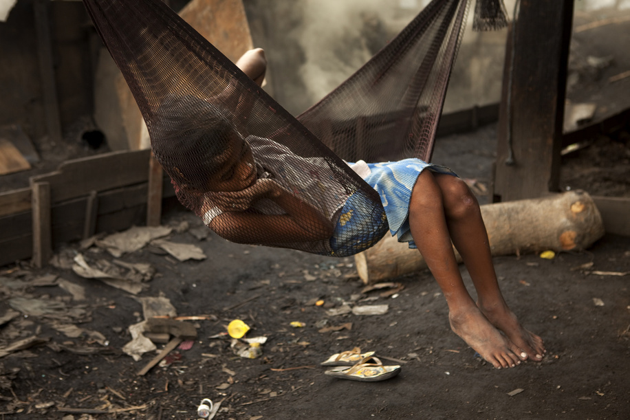 Hidden cities is a joint WHO / UN-HABITAT report about urbanization and global health issues. Photo stories from around the world reflect the hidden realities urban dwellers are facing, and highlight some health inequities.

A girl in a hammock next to the coal fires on the street in Tondo, Manila, Philippines