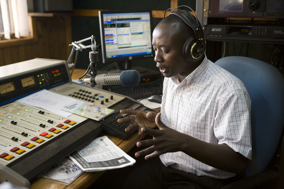 At Radio West in Mbarara, a city in the Western Region of Uganda, a DJ provides information on Marburg hemorrhagic fever. The Ugandan Ministry of Health, Centers for Disease Control and Prevention (CDC) and WHO work with local media to provide the public with key information on the disease. In addition to print, radio is an important vehicle to support informationand education campaigns. 
Marburg virus disease (MVD), formerly known as Marburg haemorrhagic fever, is a severe, often deadly illness. The Marburg virus is a close relative of Ebola, and the two zoonotic pathogens are clinically similar and lead to severe viral haemorrhagic fever in humans. Though rare, both diseases have the capacity to cause dramatic outbreaks with high fatality rates. There is as yet no proven treatment or vaccine available for MVD. In 2007, two cases of Marburg haemorrhagic fever were identified in a remote mining area in western Uganda. One, a miner, died in July. A public information campaign was launched along with training courses for local health workers. Concurrently, an international team of experts and scientists worked to identify the hosts of the virus and its mode of natural transmission in the environment. In their quest to locate the reservoir of the Marburg virus, team members explored Kitaka mine cave, where the outbreak appeared to have started. At a laboratory set up nearby, they examined bats that were captured in the mine. Working through the night, scientists searched blood and organ samples for Marburg virus antibodies. This photo story documents the joint efforts of WHO and its partners in the Global Outbreak Alert and Response Network (GOARN) to monitor, investigate, and control the outbreak of Marburg fever in Uganda.