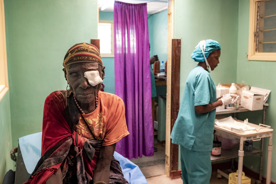 Kakuma, Kenya - 26 March, 2018: Doctor with patient Joyce before her cataract operation in her left eye in the pre-operation room of Kakuma Mission Hospital. This hospital in Northern Kenya is one of the few facilities in the region of Turkana where patients can have ophthalmologic consultation and eye related operations.