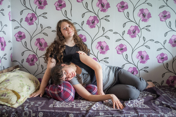 Sisters Violeta, 20 (right), and Alina, 14 (left), sit in their room at a refugee center in Chișinău, Moldova on 23 June 2022. They arrived at the centre with their mother from Nikolaev, Ukraine, in May 2022. Specialists from Neovita work with refugees at the centre.  The National Resource Centre YK Neovita is one of the first youth-friendly clinics that was launched in Moldova in 2002. It offers a multidisciplinary team of specialists, including obstetricians and gynecologists, urologists and andrologists, dermatovenereologist, HIV consultants, midwives, psychologists, social workers as well as young volunteers.