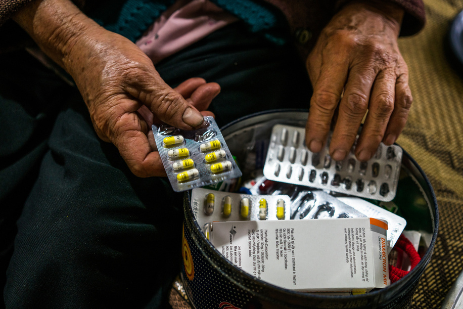 Hoa, 68, a diabetes sufferer, with her daily medications in her home in Doi Son, rural Ha Nam Province, Vietnam.