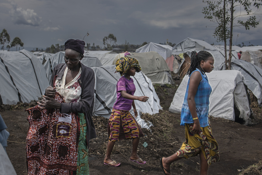 On 3 March 2023, Maisha (left), 57, stands in front of her shelter in Bulengo camp, about 15 kilometres from Goma in the east of the Democratic Republic of the Congo. She said that she had to flee her home about 1.5 months ago. 