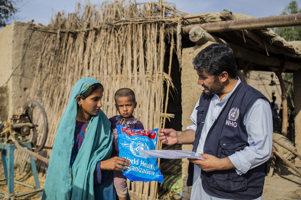 On 14 March 2023, WHO medical entomologist Syed Baseer Ahmed gives a mosquito net to Shagufta during a door-to-door campaign for malaria treatment and prevention in Sohbatpur, Balochistan. The 2022 floods resulted in the worst malaria outbreak in Pakistan since 1973. In response, international health organizations such as WHO and the Global Fund came together with local governments and NGOs to combat the malaria outbreak and help address the extraordinary scale of need. The response drew on both the oldest and newest interventions in the anti-malaria tool kit. In the makeshift refugee camps, nets were distributed, tents (and what houses remained) were sprayed with insecticides, and mass drug administration campaigns were conducted to quickly treat as many people as possible.   Related: https://www.who.int/news-room/feature-stories/detail/It-was-just-the-perfect-storm-for-malaria-pakistan-responds-to-surge-in-cases-following-the-2022-floods