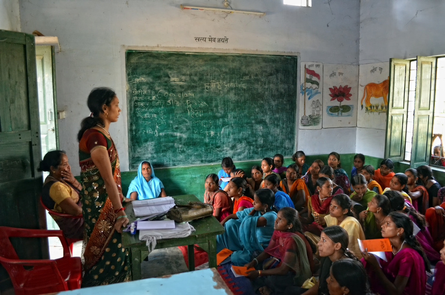 Teenage girls listening attentively and taking notes during a class on nutrition taught at a village school in Dohari, Uttar Pradesh, India.

Photos of children in and around schools in India
