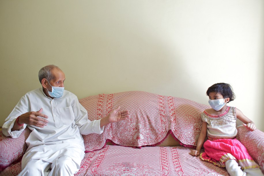 This series focuses on different aspects of having influenza in India.

A man and his granddaughter wear face masks while sitting a distance apart from each other in a middle class household of north Delhi.