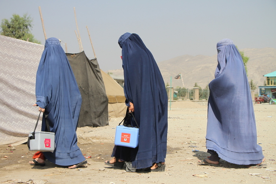 Polio vaccination campaign in Afghanistan. Afghan female vaccinators walk downtown Jalalabad to take part in national immunisation days of vaccination for children under five years old.