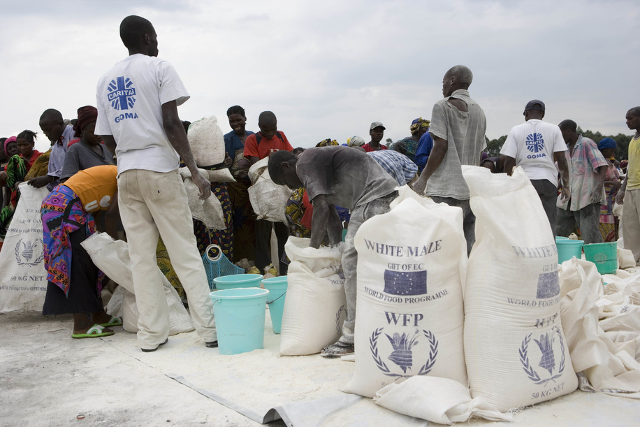 Feature about Internally Displaced People (IDP) due to conflicts in Democratic Republic of the Congo. Bags of white maize from WFP (World Food Program) and distribution.