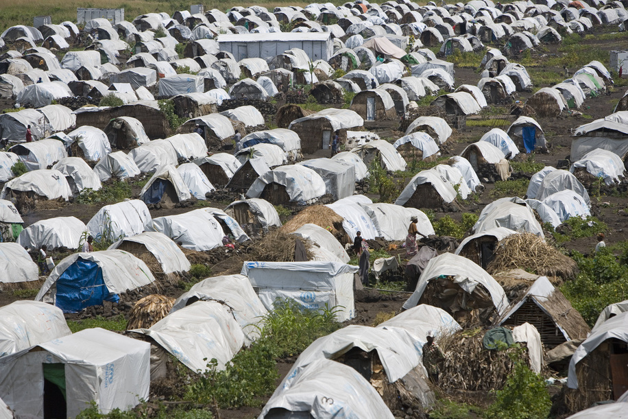 Feature about Internally Displaced People (IDP) due to conflicts in Democratic Republic of the Congo.

A view of the camp at Buhimba - rudimentary houses covered with a white tarpaulin in a field.