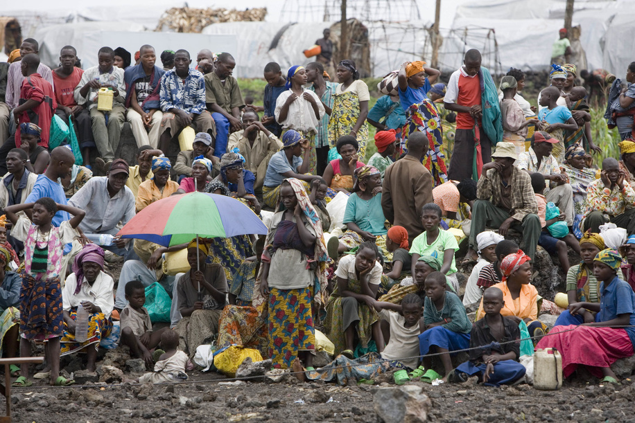 Feature about Internally Displaced People (IDP) due to conflicts in Democratic Republic of the Congo. Men, women and children waiting to get food.