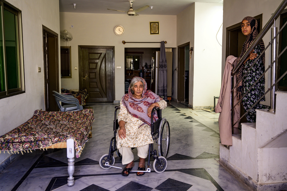 Fozia, 64 and a health worker in her family house during a field assistive technology survey for person with disabilities in the outskirts of Islamabad. 

Fozia is suffering from a paralysis since 2016, when she had a stroke while sleeping.