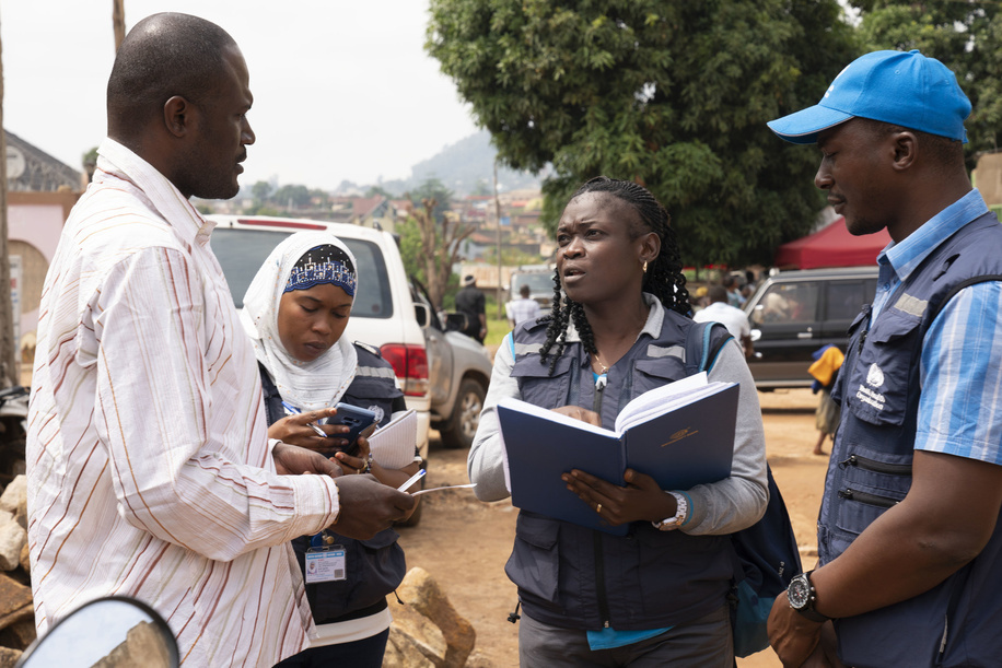 WHO’s response to Ebola virus disease (EVD) outbreak in the Democratic Republic of Congo. WHO Epidemiologist Gisele Mvumbi (centre) at work with WHO Contact Tracing teams. Here as she speaks to local village leader. - Title of WHO staff and officials reflects their respective position at the time the photo was taken.