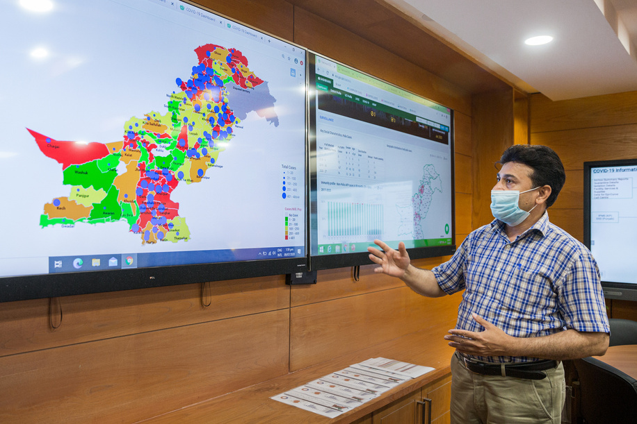 Syed Razzaq, technical officer for MIS/IT information management shows data on Pakistan's COVID-19 response at the operations room in the National Emergency Operation Centre (NEOC) for Polio Eradication, located inside the National Institute of Health.