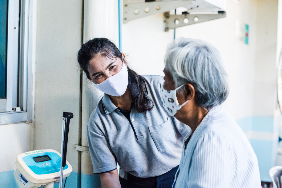 A village health volunteer gives advice to a patient at Koo Bang Luang's health promotion hospital, on 17 July 2020. Village health volunteers help keep people free from COVID-19 and other diseases.