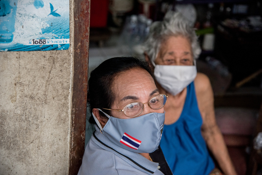 A health volunteer (foreground) and her patient (background) during a home visit on 23 September 2020, in Bang Phut Sub District.