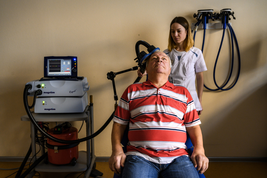 Patient during his therapy on navigational brain stimulation, transcranial myostimulation, stabilotraining/balance master at the Russian Federal Rehabilitation Center in Moscow. Diagnosis: stroke injury.