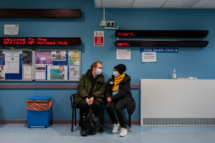 Phoebe Harkins (right), 51, waits to be called in to receive a COVID-19 vaccine at Evergreen Primary Care Centre in the London borough of Enfield in the United Kingdom of Great Britain and Northern Ireland, on 24 January 2021. She is very happy to be vaccinated.