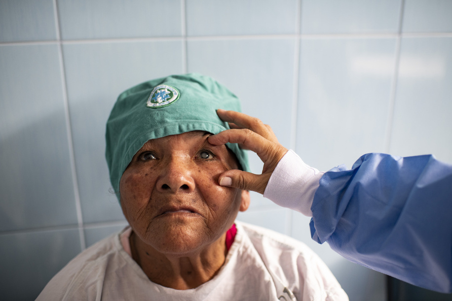 Lima - 20 March, 2018: A doctor checking Andrea Castillo Duran in the pre-operation room of the Maternal and Child Health Center Daniel Alcides Carrion in Villa María del Triunfo neighborhood in Lima. In this Health Center the priority is to have an early diagnosis on eye problems, from the kids to the elderly patients. They focus in cataracts, refractive errors, prematurity retinopathy, diabetic retinopathy, glaucoma as well as external diseases of the eye. Few years ago they even started to do their own cataract operations due the high number of patients with this pathology that they have and the over saturated health system in Lima.