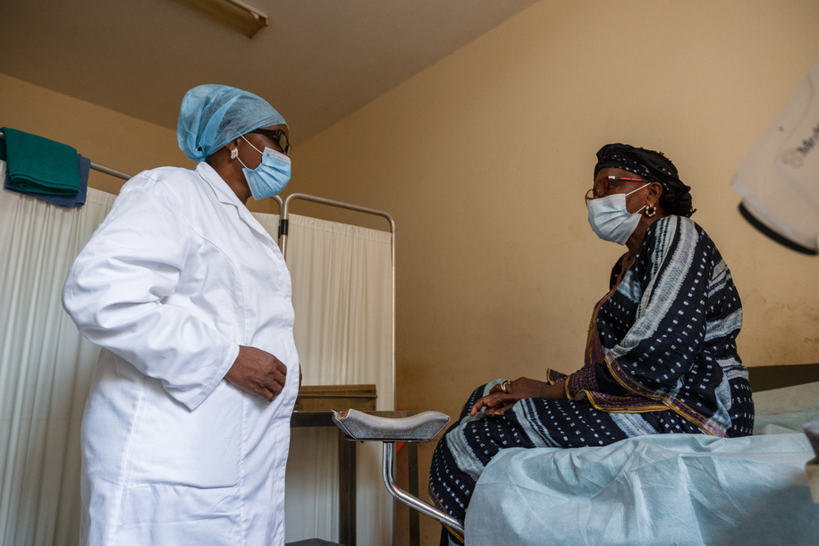 Kadiatou Diallo speaks to a doctor during an annual check up at Donka University Hospital in Conakry, Guinea. Diallo is a survivor of cervical cancer. She was diagnosed in 2010 and went into remission in 2012. 

The Francophone Regional Center for Training and Prevention of Gynaecological Cancers (Centre Régional Francophone de Formation et de Prévention des Cancers Gynécologiques) located at Donka University Hospital in Conakry, Guinea, is a regional training facility that offers screenings, training, and treatment of precancerous and cancerous lesions, including surgical treatment and chemotherapy when necessary. The Centre often hosts regional training workshops to provide technical support to African countries in order to improve their capacities for screening and preventive treatment of cervical cancer.