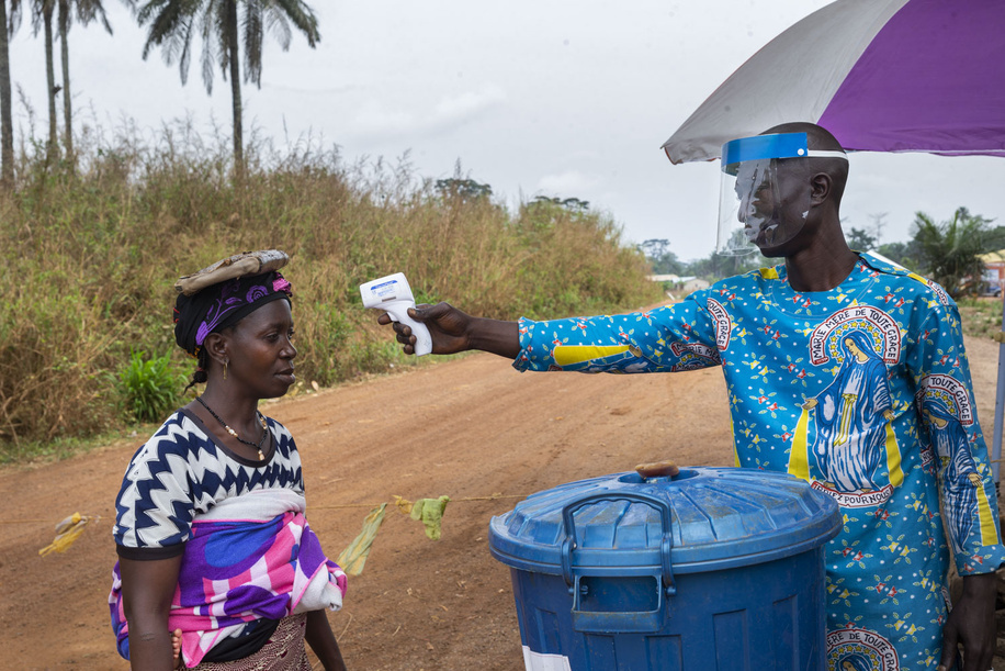 On 28 February 2021, Gerard (right) takes the temperature of a woman who is passing through a checkpoint set up on a road in the community of Gouéké to help prevent the spread of Ebola. This is the first time the disease has been reported in Guinea since the previous outbreak ended in 2016. The Ministry of Health of the Republic of Guinea announced a new outbreak of Ebola virus disease on 14 February 2021 after a cluster of cases was reported in in the sub-prefecture of Gouéké, N’Zérékoré Region. WHO is supporting the Government-led response to set up testing, treatment structures, and with medical supplies, vaccines, therapeutics, and diagnostic capacities to quickly contain the outbreak.