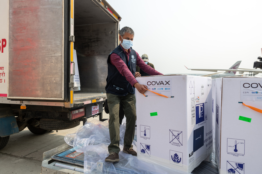 On 7 March 2021, WHO Nepal Operations Support & Logistics Officer Prahlad Dahal takes a look at Nepal's first consignment of COVID-19 vaccine doses via COVAX as they are loaded onto a truck at Tribhuvan International Airport in Kathmandu.

COVAX, the vaccines pillar of the Access to COVID-19 Tools (ACT) Accelerator, is co-led by the Coalition for Epidemic Preparedness Innovations (CEPI), Gavi, the Vaccine Alliance Gavi) and the World Health Organization (WHO) Ð working in partnership with developed and developing country vaccine manufacturers, UNICEF, the World Bank, and others. It is the only global initiative that is working with governments and manufacturers to ensure COVID-19 vaccines are available worldwide to both higher-income and lower-income countries.

Title of WHO staff and officials reflects their respective position at the time the photo was taken.