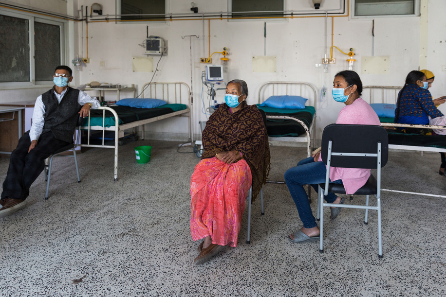 On 11 March 2021, Gopal Singh Ghale (left), Nani Maiya Shrestha (centre) and other patients rest after receiving COVID-19 vaccine at Paropakar Maternity and Women’sHospital in Kathmandu, Nepal.