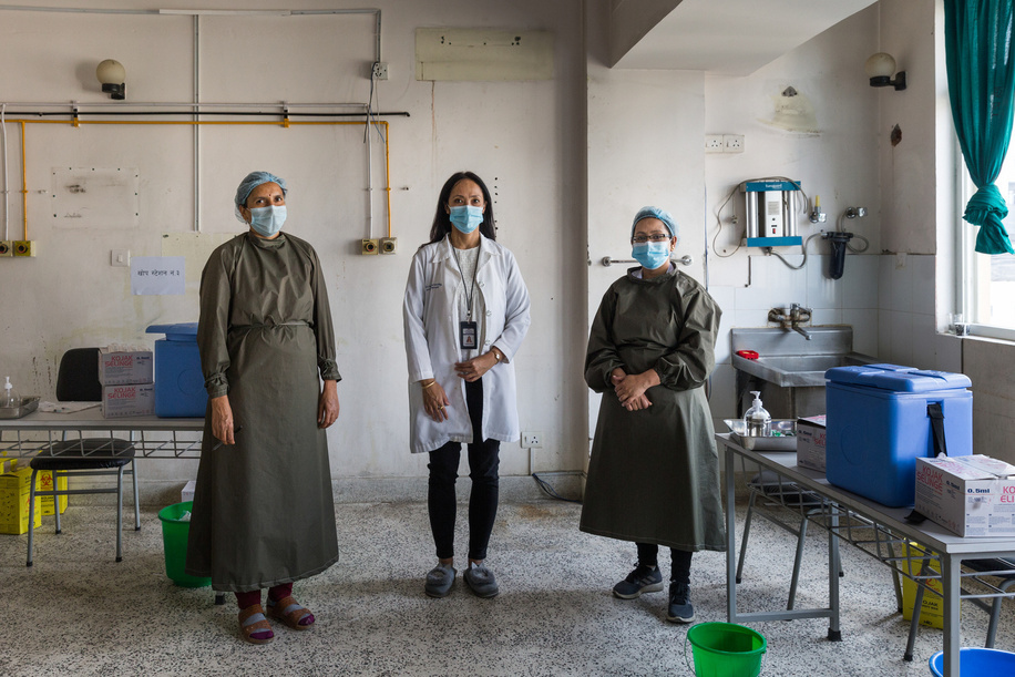 On 12 March 2021 health workers Sarita Bajagain (left), Dr Karishma Malla Vaidya (centre) and Resa Prakash Gurung (right) at the COVID-19 vaccination centre at Paropakar Maternity and Women’s Hospital in Kathmandu, Nepal.