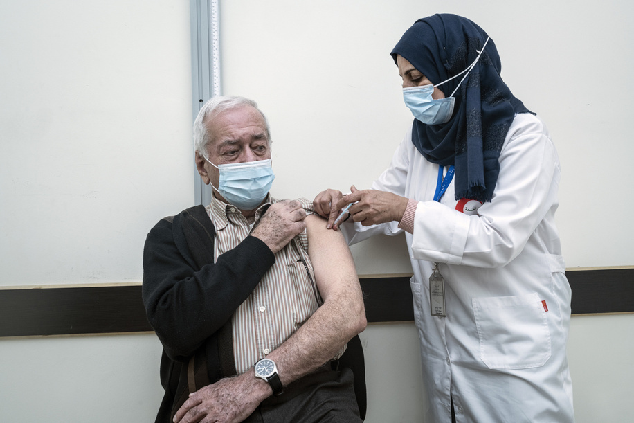 On 23 March 2021 nurse Eman H. administers a COVID-19 vaccine to Khalil, 77, at a vaccination site by the Health Directorate in Ramallah district, occupied Palestinian territory. Says Khalil, “When my grandchildren come to my house, I cannot hug them. We wave from afar because it’s dangerous and they come to understand that, even my three-year-old granddaughter. Honestly, it hurts. I want to hug and kiss her but I cannot.” Occupied Palestinian territory received its first delivery of COVID-19 vaccines on 22 March 2021 via COVAX. COVAX, the vaccines pillar of the Access to COVID-19 Tools (ACT) Accelerator, is co-led by the Coalition for Epidemic Preparedness Innovations (CEPI), Gavi, the Vaccine Alliance and WHO working in partnership with developed and developing country vaccine manufacturers, UNICEF, the World Bank, and others. It is the only global initiative that is working with governments and manufacturers to ensure COVID-19 vaccines are available worldwide to both higher-income and lower-income countries. Read also: https://www.who.int/news-room/feature-stories/detail/the-occupied-palestinian-territory-reforms-its-hospital-sector-to-make-progress-towards-universal-health-coverage  
