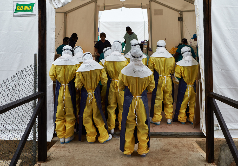 On 22 March 2014, the World Health Organization (WHO) declares an outbreak of ebola virus in Guinea. One element of the international response in Sierra Leone involves constructing additional Ebola Treatment Centres (ETCs). Behavioural change is also essential to control the epidemic. The riskiest behaviours includ attending traditional funerals, caring for the sick at home and treatment of infected patients by health workers with inappropriate personal protective equipment (PPE) or training in the use of PPE. � WHO staff from Polio, Emergencies and Country Collaboration (PEC) Department Robert Andrew Holden (not pictured) went to Freetown Sierra Leone to provide technical support and coordinate the Foreign Medical Team (FMT) activities. Caption was not provided by the photographer. Therefore, a generic caption has been applied to this image.