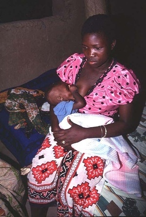 Beautiful Mother Big Breast Breastfeeding Her Foto stock 1067406545