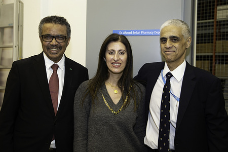 The effort to establish the depot was led by Dr Ahmed Bellah. For years, he has expressed concern about the suboptimal and uneven storage arrangements for medicines and diagnostics at WHO headquarters. “He saw a problem, and he was determined to do something about it. He refused to give up, even over many years, until he succeeded,” said Dr Tedros.  Dr Bellah proposed the creation of a compliant pharmacy depot during a discussion with Dr Tedros in one of his early open hours sessions. Dr Tedros then tasked General Management (GMG) cluster to work with Dr Bellah on a solution. The new pharmacy depot is the result.    The upgraded depot allows monitoring and controlling the temperature and humidity conditions through sensors and physical inspections to maintain optimum storage temperatures of 15-25°C. Access to the premise is also electronically monitored and controlled, and the depot and its infrastructure are connected to the emergency power supply to ensure 24/7 operability. Inventory movements are tracked and recorded in the GIMS data base system to enable accurate real-time overview of stock.  Dr Bellah thanked Mike Ward, his supervisor, and the current pharmacist, Sophie Laroche and other colleagues for supporting not only his idea but all the work it took to bring the project to fruition. Before cutting the ribbon, Dr Bellah was asked to remove the tape covering the room sign on the door – revealing his very own name, the “Dr Ahmad Bellah Pharmacy Depot”.  Assistant Director-General for GMG, Stewart Simonson, underlined that the new depot enables WHO to guarantee the quality and traceability of the pharmaceutical products kept on its premises and supplied to Member States from Geneva headquarters. “It turned out even better than we all thought it would, it’s a wonderful achievement, and I am grateful for Ahmed’s vision and persistence,” he said. Title of WHO staff and officials reflects their respective position at the time the photo was taken.  