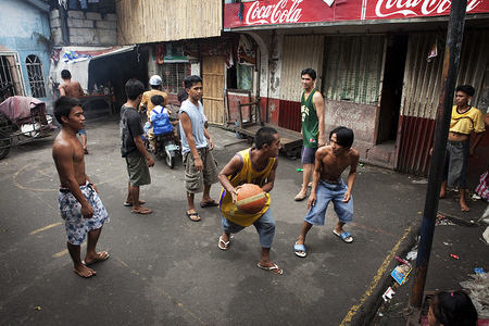 Hidden cities is a joint WHO / UN-HABITAT report about urbanization and global health issues. Photo stories from around the world reflect the hidden realities urban dwellers are facing, and highlight some health inequities. Young men play basketball in Parola, Manila, Philippines.