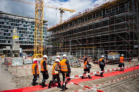 Members of the 145th session of the WHO Executive Board and WHO staff arrive to the construction site of the new WHO building for the first stone ceremony.