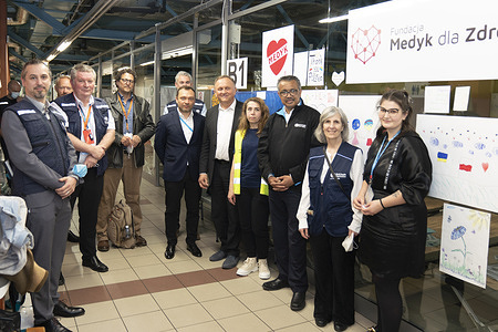 WHO Director-General Dr Tedros Adhanom Ghebreyesus and WHO Team visit to Centrum Medyczne's reception centre, Rzeszow on 5 May 2022. They are greeted by coordinator Klaudia and founder Dr Mazur. For the last two months, the centre has been a safe shelter for some 6000 people as they arrive to Poland, staying a few days and moving on to other locations and accommodations. The space, originally a shopping center, had been converted into a COVID-19 Vaccination site and then was repurposed as a reception centre with beds, family space, pharmacy, nurse, kitchen. Currently 100 people staying there.