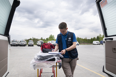 On 13 May 2022, WHO biomedical engineer Dmytro Osin inspects ambulances that were recently delivered to the WHO warehouse in Lviv, Ukraine.
