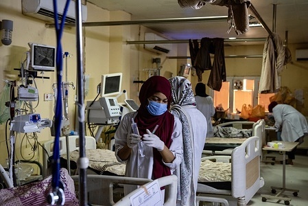 A nurse at work in the ICU at the Ibrahim Malik Teaching Hospital on 23 April 2022. The hospital is the one of the largest public hospitals in Khartoum, with an estimated 700 - 1000 patients visiting each day. However, amidst ongoing instability in Sudan, the hospital faces challenges with retaining trained staff and ensuring adequate supplies and funding. "Our biggest aim right now is just to keep the doors open," said Emergency Department Head Dr Osama Muhammad Ali. WHO supports the hospital via the Global Emergency Trauma Care Initiative (GETI). Through GETI, WHO and partners support low- and middle-income countries to assess their national emergency care systems, identify shortcomings and implement proven interventions to address these gaps. https://www.who.int/initiatives/global-emergency-and-trauma-care-initiative