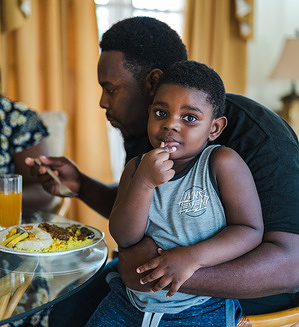Stevie (left) and Christon (right) enjoy a typical family meal in the home of Stevvalyn (not pictured). Family is very important to Stevvalyn. As one of the main caregivers in her extended family she makes a conscious effort to provide balanced and healthy meals. Stevvalyn took part in a chronic disease self-management course, implemented by PAHO/WHO with the support of the Universal Health Coverage Partnership. Through the course, they and other participants learned about the different aspects of managing noncommunicable diseases including getting a good night’s sleep, the mind-body connection, physical activity and exercise, healthy eating, reading food labels and making informed treatment decisions. The course also covered important areas like problem solving, dealing with difficult emotions, communication skills and making an action plan. Along with developing skills to manage their conditions, participants also learned how to roll out the same training in their own communities and contexts, such as with religious groups and in health care settings. Trinidad and Tobago, like many countries around the world, is facing a growing burden of noncommunicable diseases (NCDs) such as heart disease, stroke, cancer, diabetes and chronic lung disease. These chronic conditions account for over 62% of deaths each year, with three quarters occurring in people under 70 years old. Over half of the country’s population has 3 or more risk factors for NCDs, such as poor nutrition, physical inactivity and harmful use of alcohol and tobacco, placing them at greater danger of developing a chronic illness. The country’s experience shows that empowering and equipping communities to take charge of their health through prevention and self-management of NCDs - a primary health care approach - is an effective way to build healthier populations.   Trinidad and Tobago is among the 115 countries and areas to which the Universal Health Coverage Partnership helps deliver WHO’s support and technical expertise in strengthening health systems to achieve health for all.   https://www.uhcpartnership.net/story-trinidad-and-tobago/