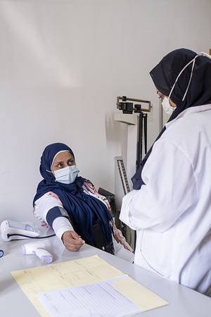 Victoria Chaarawy (right) checks the blood pressure of a patient on 3 August 2022 at Rjail Arbaeen Primary Health Center .     Patients visiting this center may be enrolled in routine influenza surveillance if they have certain symptoms. If they are enrolled, a sample will be collected and tested for respiratory viruses. This health centre functions as a sentinel site for influenza-like illness surveillance. Respiratory samples are collected from symptomatic patients and tested for influenza, SARS-CoV-2 and other respiratory viruses. Information from this routine surveillance is important to inform national, regional and global actions on preparing and responding to respiratory viral diseases.