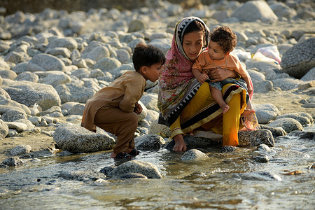 Children whose home was damaged by the flooding play in a stream in Madyan in Pakistan's Swat valley on 1 September 2022. Catastrophic floods in Pakistan in August 2022 killed some 1,400 people, destroyed more than half a million homes and displaced over 660,000 people into camps. Many more people are displaced in host communities. More than 750,000 livestock – a critical source of income for many families – died after the rainfall, which in August was more than five times the national 30-year average in some parts of Pakistan. According to the Food and Agriculture Organization, the floods damaged 1.2 million hectares of agricultural land in Sindh Province alone. Some 33 million people have been affected, and access to many vulnerable communities was cut off as hundreds of bridges and thousands of kilometres of roads were destroyed or washed away.  WHO is supporting the Government of Pakistan to respond by delivering supplies needed by health facilities and increasing disease monitoring to prevent the spread of infectious diseases. https://www.who.int/emergencies/situations/pakistan-crisis