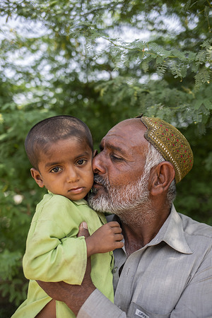On 14 March 2023, Samandar holds his 3-year-old son Nazeer at a basic health unit supported by WHO. Nazeer tested positive for malaria for the second time in the past six months.  The 2022 floods resulted in the worst malaria outbreak in Pakistan since 1973. In response, international health organizations such as WHO and the Global Fund came together with local governments and NGOs to combat the malaria outbreak and help address the extraordinary scale of need. The response drew on both the oldest and newest interventions in the anti-malaria tool kit. In the makeshift refugee camps, nets were distributed, tents (and what houses remained) were sprayed with insecticides, and mass drug administration campaigns were conducted to quickly treat as many people as possible.   Related: https://www.who.int/news-room/feature-stories/detail/It-was-just-the-perfect-storm-for-malaria-pakistan-responds-to-surge-in-cases-following-the-2022-floods