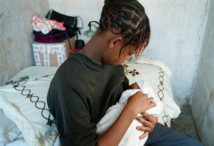 One week after birth Hiwot is taking care about her baby Elizabeth. She is not sure weather to keep the baby or hand it over for adoption. She is staying at home all day long. She feeds her baby (breastfeeding) sleeps and reads books. Her mum is taking care about the house. This feature is one of the six photo stories of Great Expectations project for the World Health Day 2005: six mothers living in different countries of the world share their experiences of pregnancy and childbirth. In Ethiopia, the photographer has been following Hiwot, from her pregnancy to the birth of her daughter, Elizabeth. Debre Zeit, Ethiopia, January 8 2005