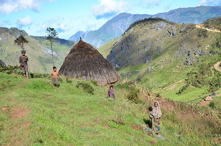 Feature on life in Timor-Leste A family stands next to their hut in the mountains of Timor-Leste.