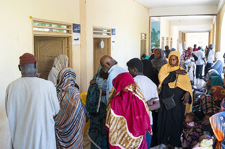 People wait to visit the mobile health centre in Barakat School in Wad Madani on 22 October 2023. The school is now a host centre for internally displaced people (IDPs) from Khartoum. The mobile clinic in Barakat School, which is supported by WHO, serves the 85 IDP families who live in the school and hundreds of families who live in neighbouring IDP sites, as well as the host community. The staff of the health centre said that they see more than 200 people daily. Related: https://www.who.int/emergencies/situations/sudan-emergency  