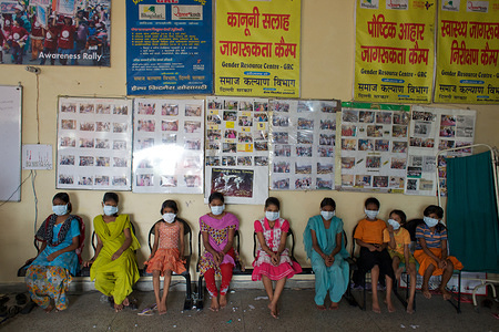 This series focuses on different aspects of having influenza in India. Children wearing face masks in an education group run by the Health Fitness Trust NGO for a community residing in a slum in Delhi.