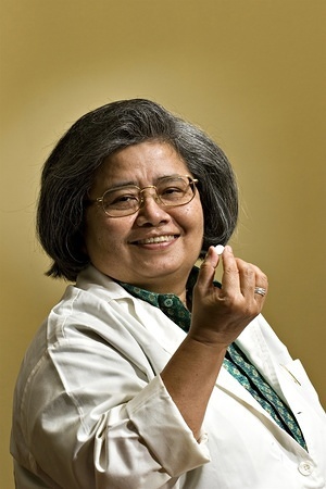 A portrait of Dr Krisana Kraisintu, whose pioneering work in generic drugs for the treatment of both AIDS and malaria has opened the door to treatment of these ailments to millions of poor people in places like Asia and Africa. Her drugs are now so affordable that, for example, people with HIV in Thailand can now get the drugs for free. These generic versions of the big pharma/drug company brand names have generally brought about a lowering or prices all over the world. The anti-malarial drug Thaitanzunate that she developed and her version of AZT (the anti-retroviral drug) GPO-Vir - a single-pill combination of three Aids drugs - are now widely available to people living on less than $2 a day.