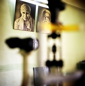 Two portraits hang on a wall next to a vision test device in Aravind Eye Hospital. This series of photos showcases stories of people from different countries living with chronic diseases and common underlying risks. In a world where more and more people are dying as a result of chronic diseases, and many more millions are disabled, these stories aim to demonstrate the strong and personal impact of chronic diseases on individuals and their families.