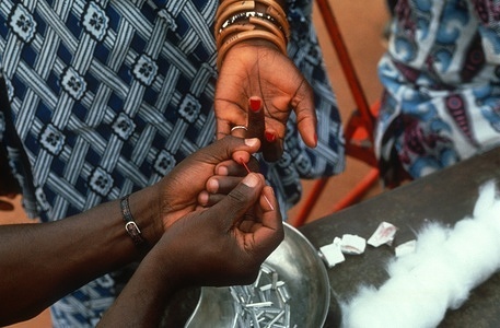 Blood being taken from an inhabitant of a village 30 km from Daloa. Surveillance of populations at risk is a main factor in the control of sleeping sickness. The Card Agglutination Test for Trypanosomiasis (CATT) is being used to screen blood for signs of infection in populations in 12 gambiense sleeping sickness endemic countries.