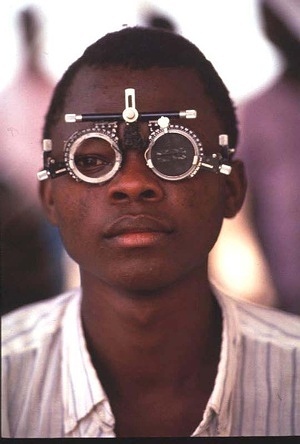 A teenage boy undergoing an eye test at a field clinic. Patients register for eye tests, ocular examination and distribution of ivermectin to those who are infected. ophthalmic instruments, eye examination equipment, ophthalmology equipment, eye examination, examination, ophthalmic supplies,