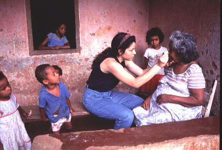 Dr Adelia examining Maria at her home near Belo Horizonte. Free medical care is extended to people in the village in return for blood samples. Many members of the family, especially children, have suffered from schistosomiasis.