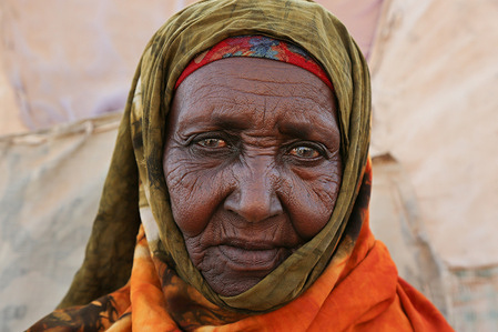 Hodan, 70, poses for a portrait in front of her house in Jigjiga Yar neighborhood in Hargeisa city. This was during the national immunisation campaign in Hargeisa, Somalia, on 28 March 2019.
